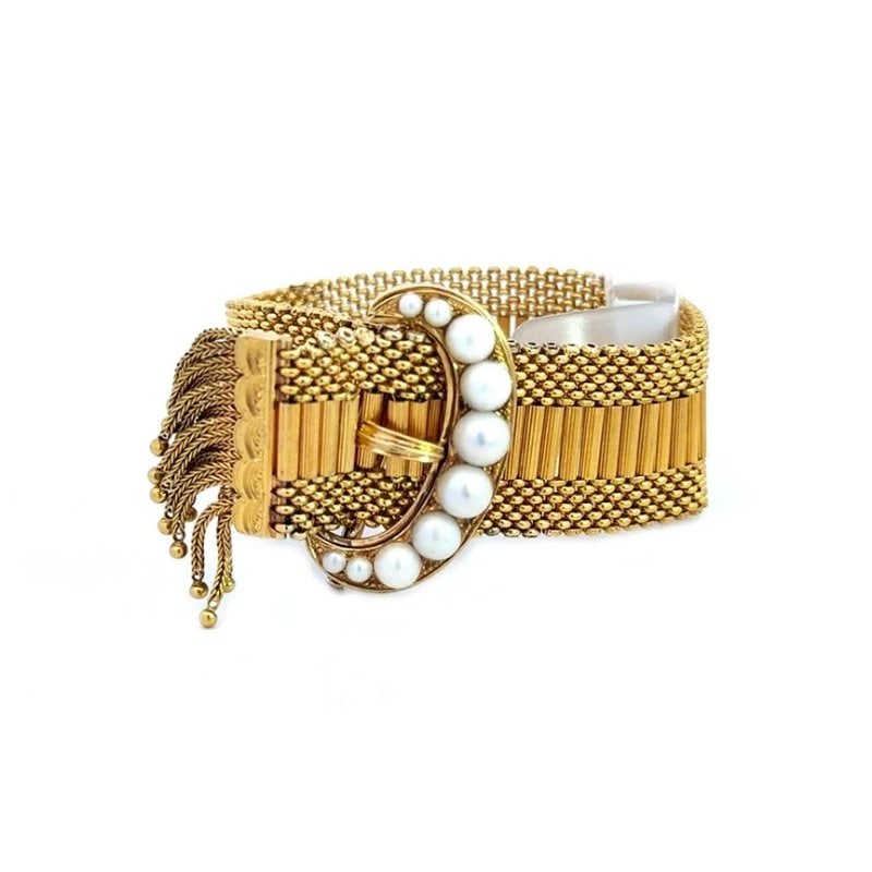 Gold 20k Mesh Tassel Belt Bracelet Pearls Crescent Buckle Soft Flex Links: The Gold 18 to 20k Mesh Tassel Belt Bracelet is a vintage piece of fine jewelry featuring a unique design with a belt shape and tassel accents. Made of yellow gold with a fine mesh and grooved bar
