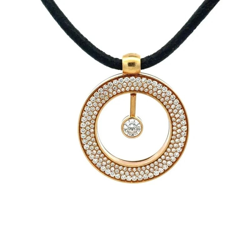 Roberto Coin Cento Gold Pendant 18k Yellow Kinetic-Swinging Cord Necklace: The Roberto Coin Cento Gold Pendant is a stunning piece of fine jewelry crafted from 18k yellow gold. The pendant features an open circle encrusted with 3 rows pave set natural white diamonds and a ce