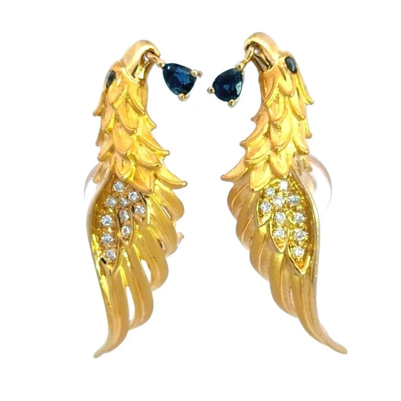 Carrera y Carrera Aguilas Earring Diamond Gold 18k Yellow Clip On Bird/phoenix: These charming diamond and gold earrings are by Carrera y Carrera from the Aguilas Collection. The pair features an eagle with a dangling pear shaped blue gemstone from its beak and blue gem eye. The 