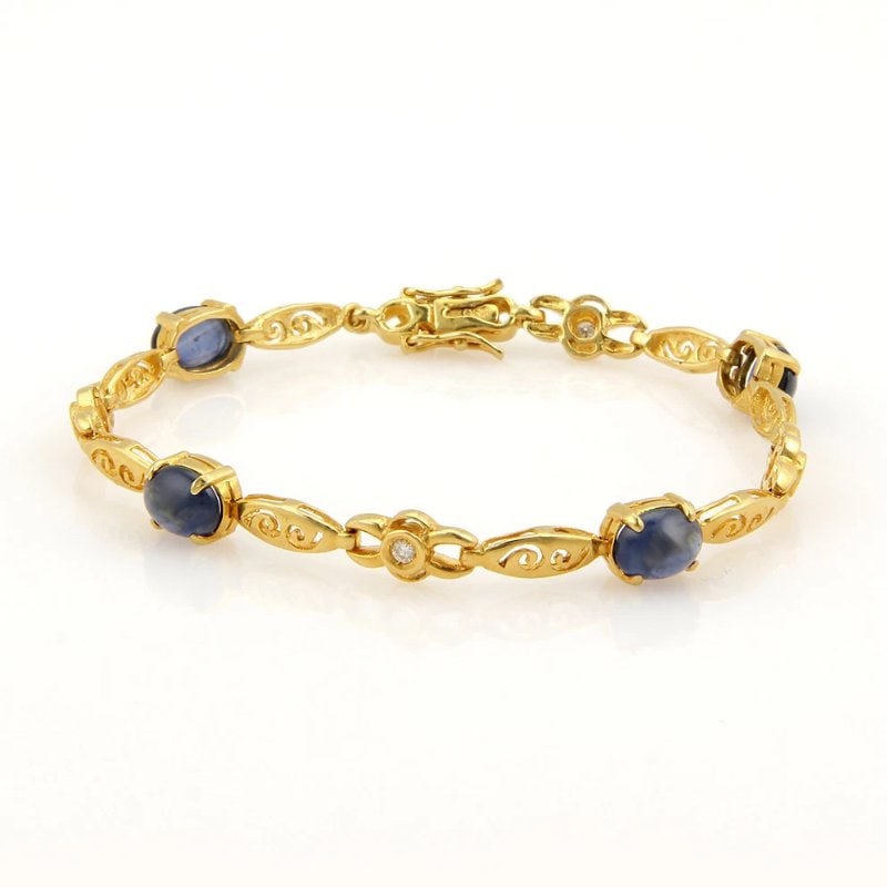 Diamond Gold Bracelet Sapphire 20k Yellow Scroll Filigree Links: This fabulous piece is finely crafted from 20k yellow gold. It features beautiful oval cabochon blue sapphire along with sparkling diamonds set on alternation marquise and oval shape and round links. 