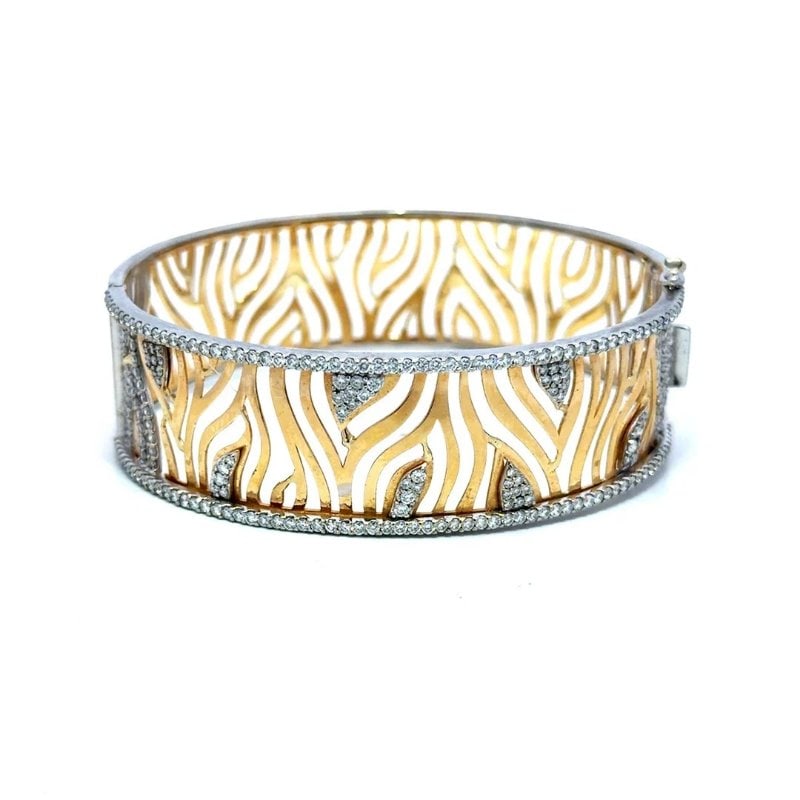 Diamond Gold Wide Bracelet 18k Two Tone Zebra Cut Out Filigree Hinged Band: This charming bracelet is crafted from 18k yellow and white gold featuring animalier theme with zebra-print openwork filigree wide bangle. The cutout pattern mimics the organic, flowing stripes of a z