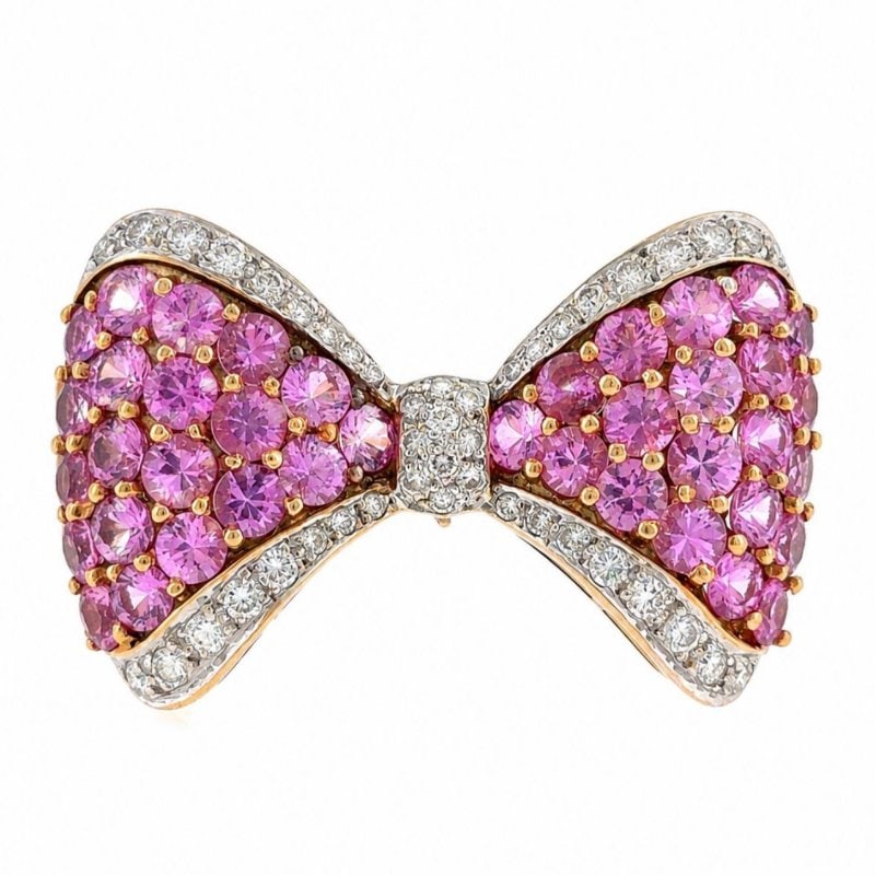 18K Yellow Gold Pink Sapphire & Diamond Ribbon Brooch: 18K Yellow Gold Pink Sapphire & Diamond Ribbon Brooch Weighing 11.5 gramsSet with 44 Diamonds weighing app. 1.20 Ct. G-H color, VVS-VS clarityAlong with 40 Pink Sapphires weighing app. 6.00 Ct.1.25 in