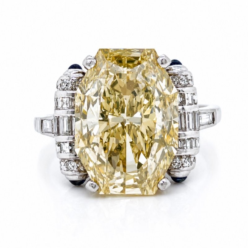 Art Deco Platinum GIA Certified 7.65 Ct. Fancy Yellow Diamond Ring: Art Deco Platinum GIA Certified 7.65 Ct. Fancy Yellow Diamond Ring Weighing 7.3 gramsSet with a GIA Certified 7.65 Ct. Octagonal Brilliant Diamond Fancy Brownish Yellow Color, SI2 Clarity 14.95 x 10.5