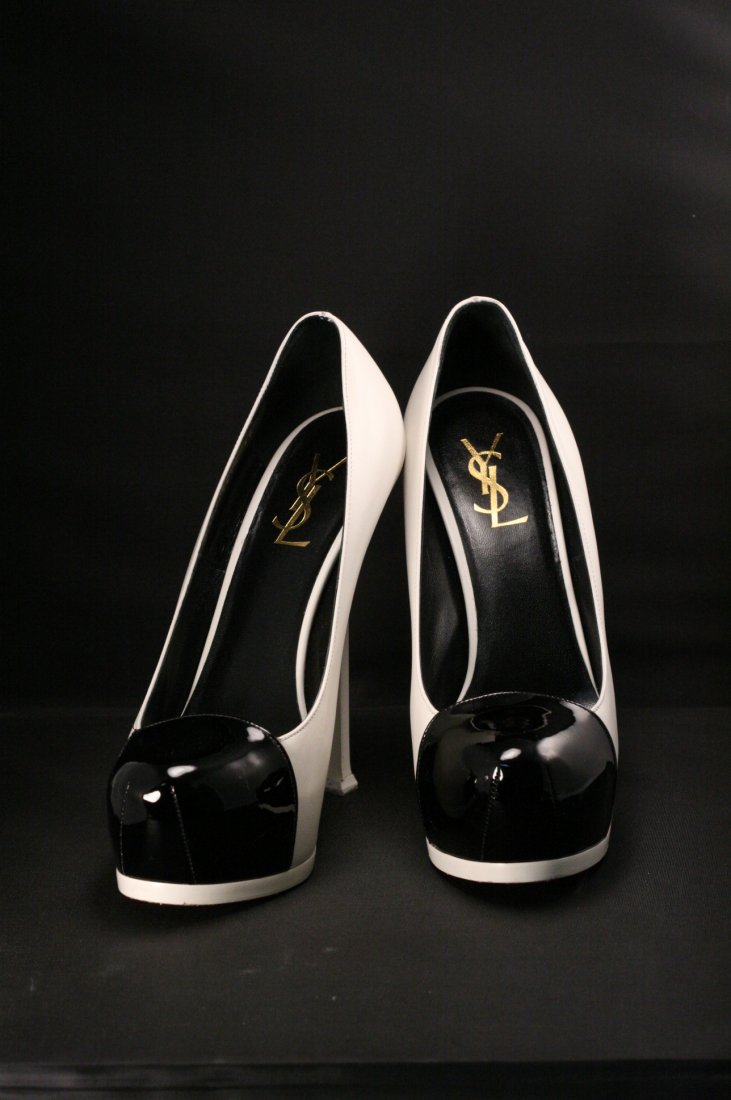 YVES SAINT LAURENT PARIS HEELS. BLACK PATENT LEATHER: YVES SAINT LAURENT PARIS HEELS. BLACK PATENT LEATHER TIPPED TOE WITH IVORY LEATHER ARCH AND HEEL. EURO SIZE 39 (US 8.5)