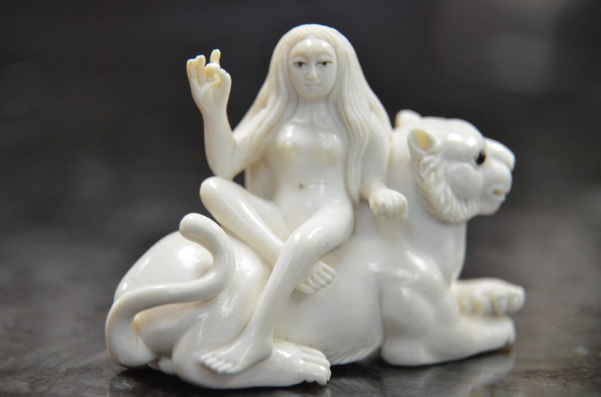 IVORY NETSUKE OF NUDE WOMAN ON TIGER: EYE CATCHING IVORY NETSUKE OF NUDE WOMAN ON TIGER. APPROX. 2 X 1.24" VALUE $600
