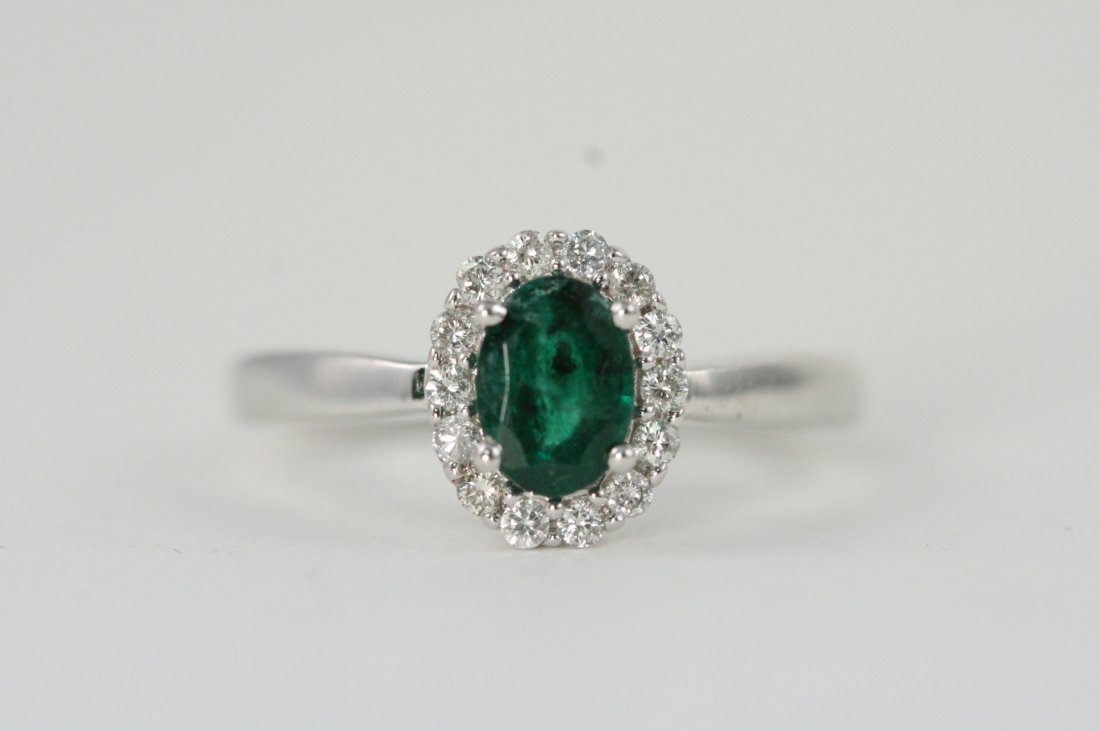 14K W/G RING WITH A BEAUTIFUL EMERALD AND DIAMONDS: 14K W/G RING WITH 1.04CT EMERALDS AND .25CT DIAMONDS. THE BAND HAS A SOLITAIRE DIAMOND ON ONE SIDE OF IT. GIVING IT A VERY UNIQUE TOUCH.