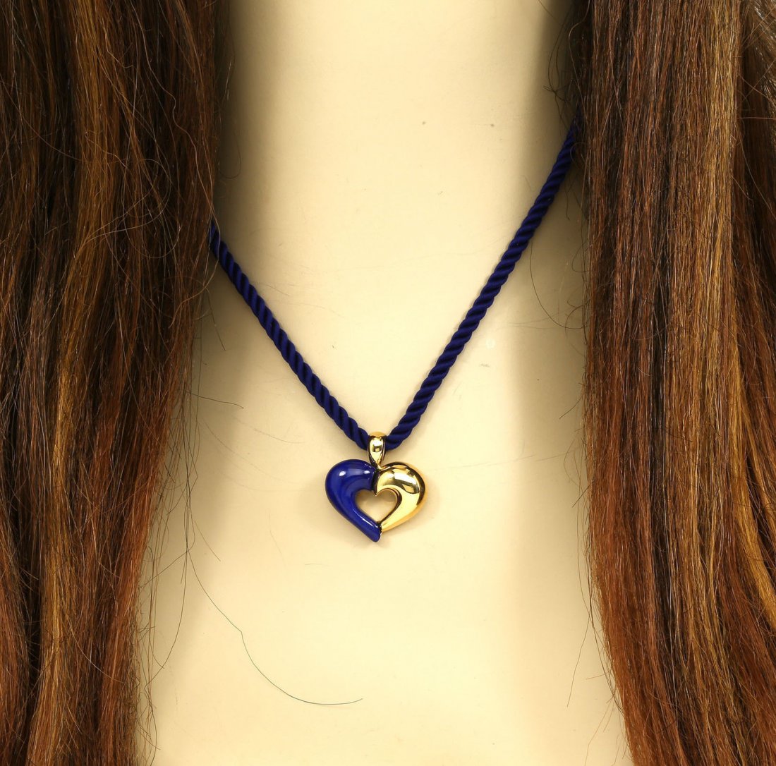 VAN CLEEF & ARPELS 18K YELLOW GOLD & BLUE LAPIS HEART: This is a designer Van Cleef & Arpels 18k yellow gold and blue lapis heart pendant with blue neck cord. The piece features a solid 18k yellow gold heart shaped pendant adorned with a hand-carved piece