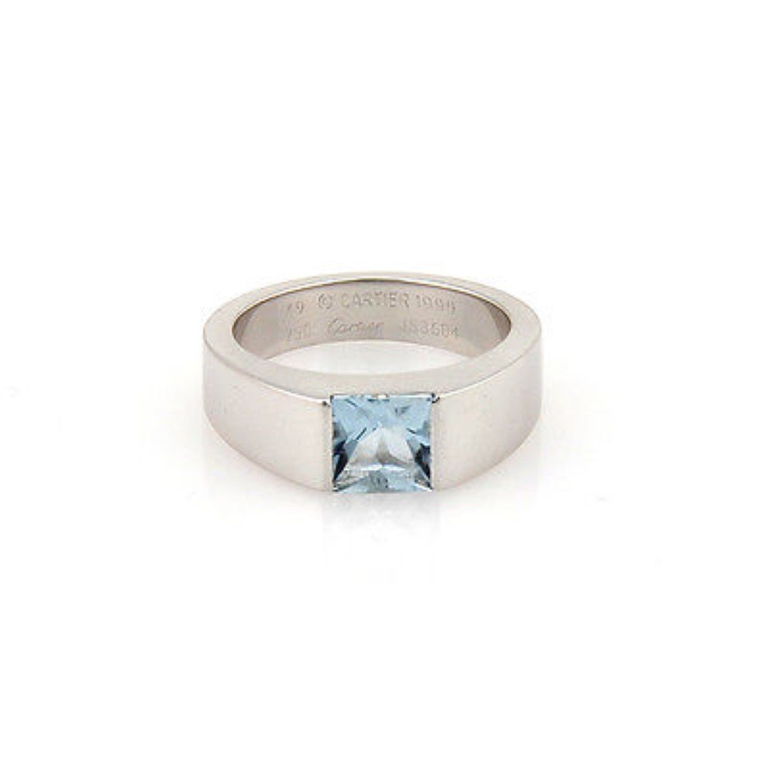Cartier 18K White Gold Aquamarine Solitaire Designer: This authentic Cartier ring is finely crafted from solid 18K white gold. It features a beautiful aquamarine gemstone which looks absolutely beautiful on the finger. It is fully signed with Cartier, th