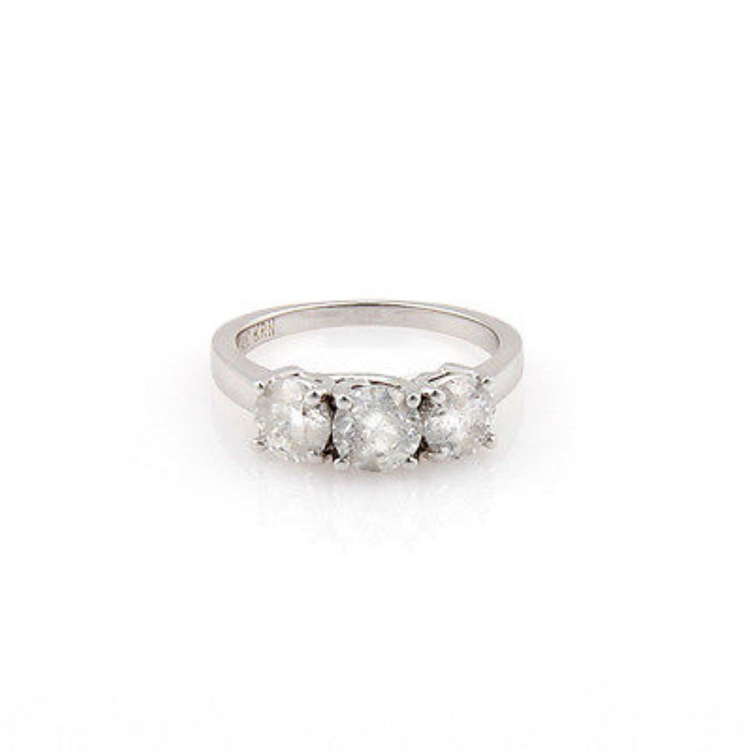 New 14K White Gold 3 Stone RoundÂ Diamond Solitaire: This gorgeous piece is finely crafted from solid 14k white gold. It features a gorgeous 3 stone design . The gold content is stamped on the inside of the shank. This ring is brand new with tags. DETAI