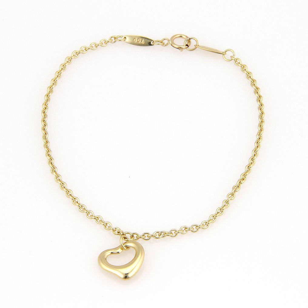 TIFFANY & CO. ELSA PERETTI SPAIN 18K YELLOW GOLD OPEN: This authentic Tiffany & Co piece is finely crafted from solid 18k yellow gold. It comes from Tiffany's ever so popular Open Heart collection and looks absolutely gorgeous on the neck. It is fully sig