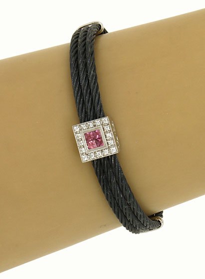 DESIGNER PHILIPPE CHARRIOL 18K, STEEL & DIAMONDS BANGLE: This is a designer Philippe Charriol 18k gold, stainless steel, diamonds and pink sapphires ladies bangle bracelet. The piece is composed of three black stainless steel wires attached to white gold pi