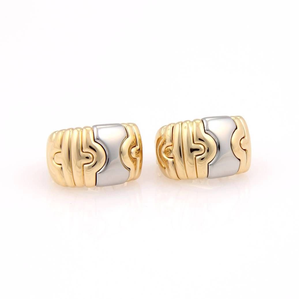 Bvlgari Bulgari 18K Yellow Gold & Stainless Steel 2: These authentic Bvlgari earrings are finely crafted from solid 18k yellow gold and stainless steel. They feature a striking 2 tone huggie design along with omega backs for a comfortable secure fit. Th