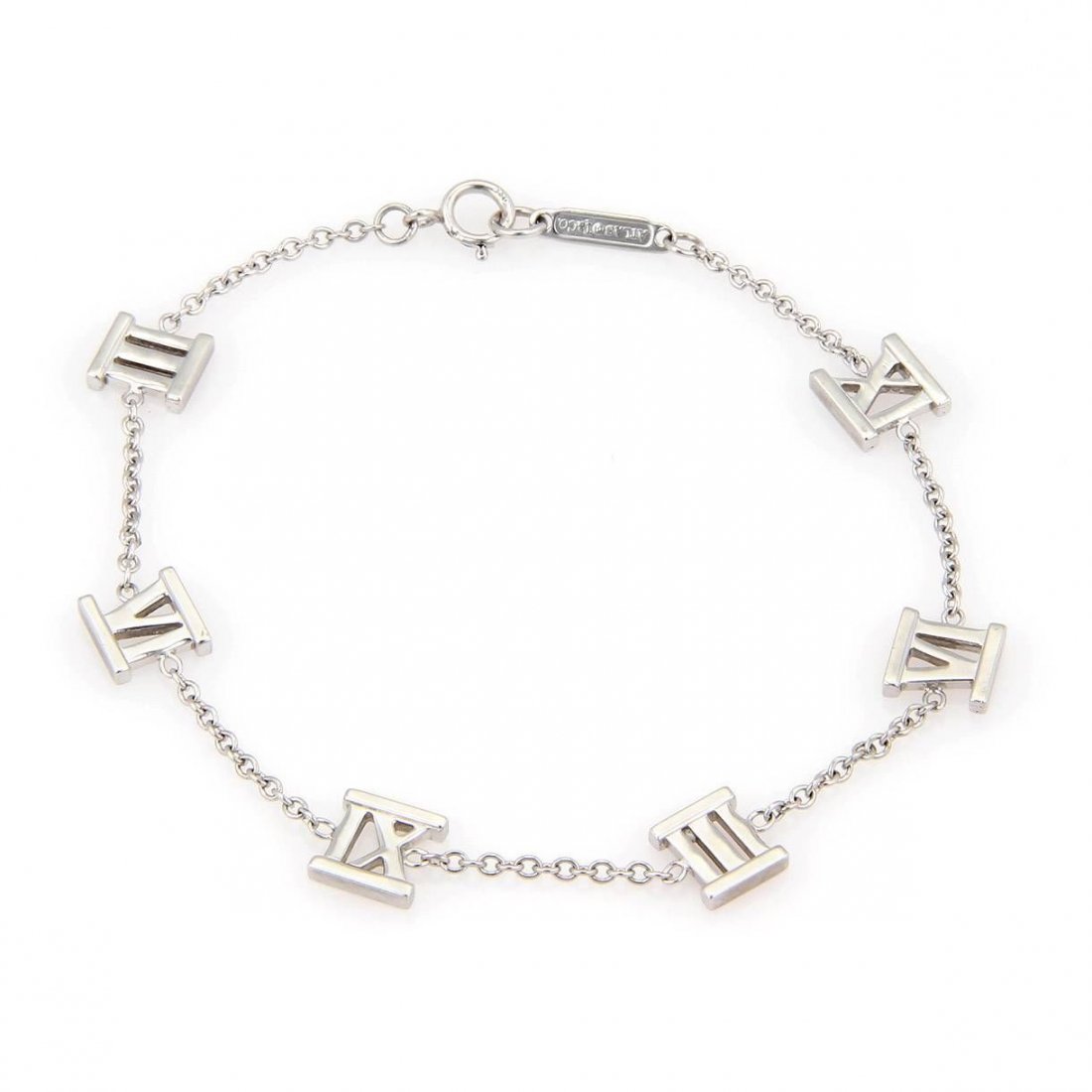 Tiffany & Co. Atlas 18kt White Gold Six Roman Numerals: This is an authentic bracelet by Tiffany & Co Atlas. It is crafted in solid fine polished 18kt white gold, in a slim chain link bracelet designed with six Roman Numeral charms, each charm attach about