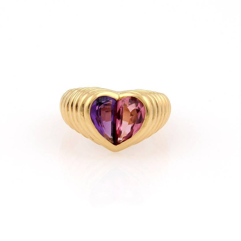 Bulgari "Bvlgari" 18kt Yellow Gold Amethyst & Pink: Up for your viewing is a charming ring by Bvlgari, it is crafted in solid 18kt yellow gold and has a concave like heart with two halves of a heart, each halves consist of an Amethyst and Pink Tourmali