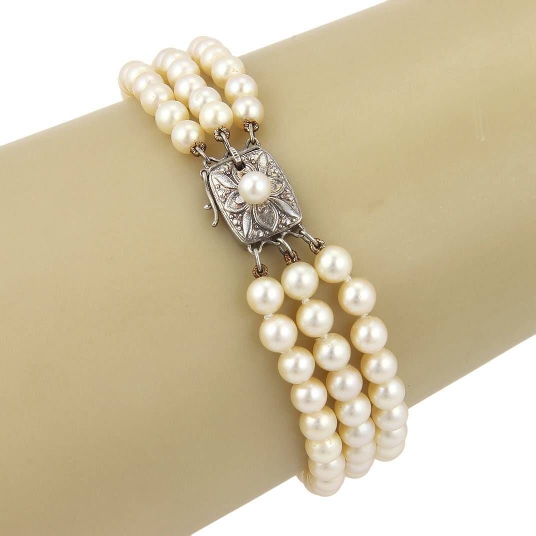 Vintage Estate Mikimoto 5mm Pearls & Silver Three: This is an elegant Vintage Mikimoto three strand pearl bracelet with push in clasp. This gorgeous bracelet has one hundred lustrous 4.5-5mm pearls with two silver spacers, the silver clasp holder has 