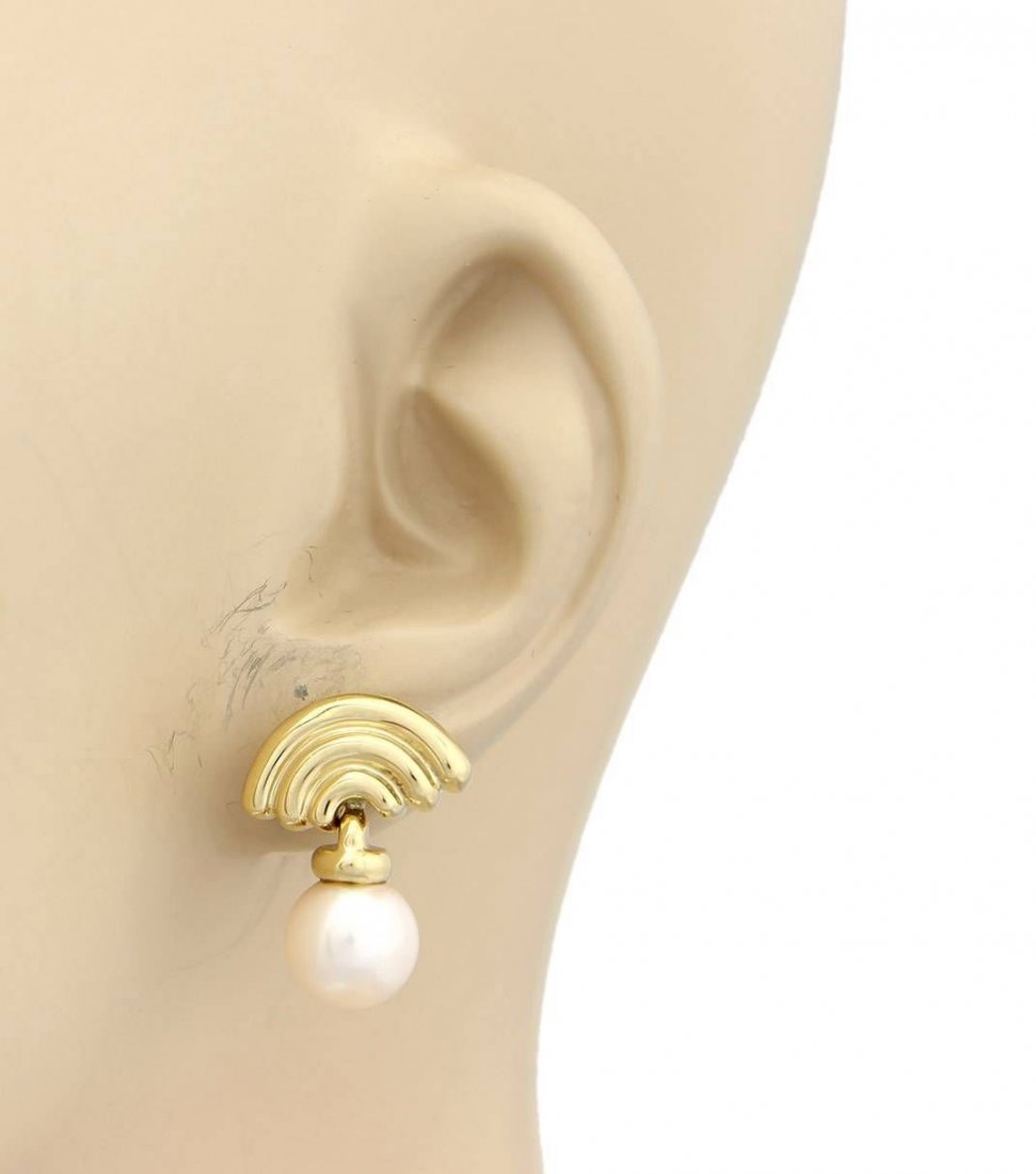 Bvlgari Bulgari 18k Yellow Gold Fancy Pearl Drop: These authentic Bvlgari earrings are finely crafted from solid 18k yellow gold. They feature a beautiful triple arch design at the top followed by a lovely pearl which dangle from the bottom. They are