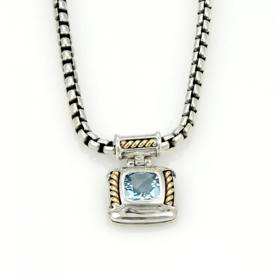 David Yurman 925 Silver 18k Yellow Gold Blue Topaz: From his Silver Ice collection, this authentic pendant and chain designed by David Yurman, and is crafted in solid 925 sterling silver with 18kt yellow gold accent. The classic square shape pendant ha
