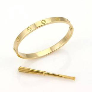 Cartier 18k Yellow Gold Love Bangle Bracelet &: This elegant and sophisticated bracelet is by Cartier, from the LOVE collection . It is well crafted from 18k yellow gold in a high polished finish with an oval shape form and screw top motifs. A brac