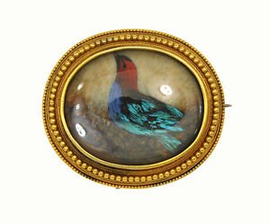 Antique Victorian 14kt Yellow Gold Oval Frame Hand: This is a magnificent and rare antique Victorian yellow gold handpainted bird brooch. The piece is well crafted in solid 14k yellow gold with a beaded oval frame design with a pretty hand bird behind
