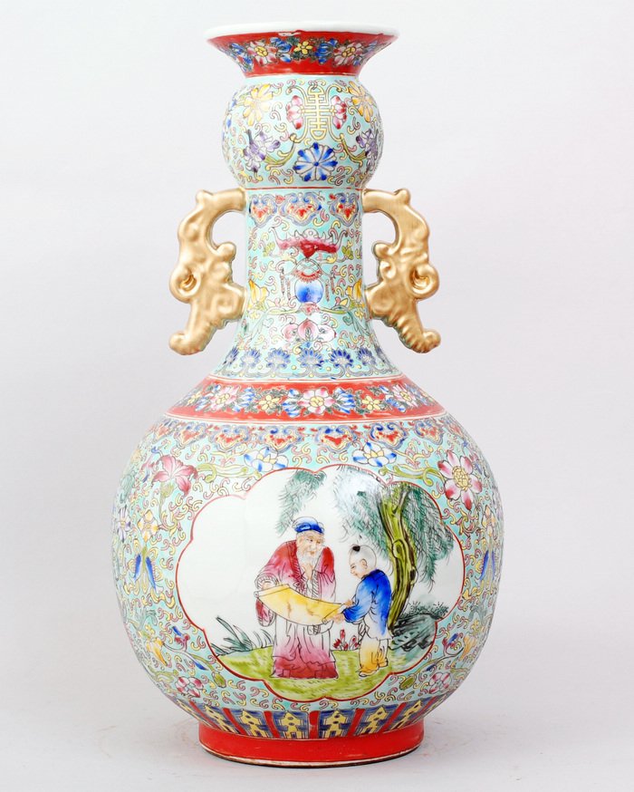 CHINESE FAMILLE ROSE PORCELAIN VASE: VASE WITH TWO GOLD HANDLES, LIGHT GREEN BASE,FLORAL AND BATS AS RAISED DESCRIPTION. PICTURES WITH TWO FIGURES UNDER THE TREE IN FRONT & BACK. SEAL MARK FOR GREAT QIANLONG PRODUCTION IN UNDERGLAZE BLUE