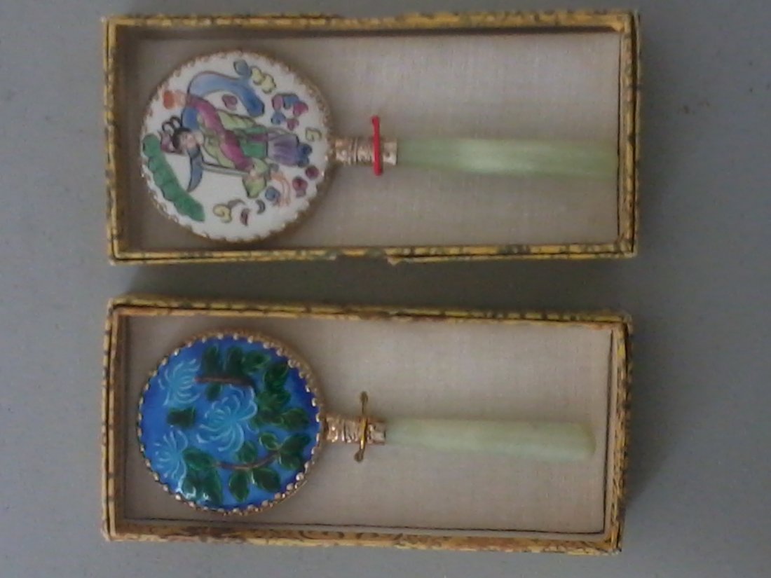 Pair of Chinese jade hand mirrors: Pair of hand mirrors with a jade handles,both enameled on the opposite side of the mirror ,one depicting flowers on the blue back ground,other depicting a lady on the white back ground,H.5.3",W.2.5".