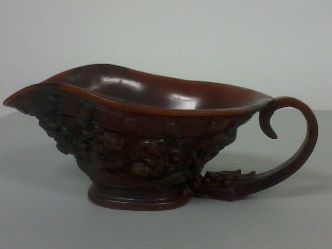 Very finely carved Chinese horn cup with handle: Ancient Rhino Horn Carved Wine Cup FOUR POWERFUL DRAGONS INCISED, The motif of this wine cup is to live a happy and carefree life,brim of the mouth was decorated with auspicious coiling dragon pattern