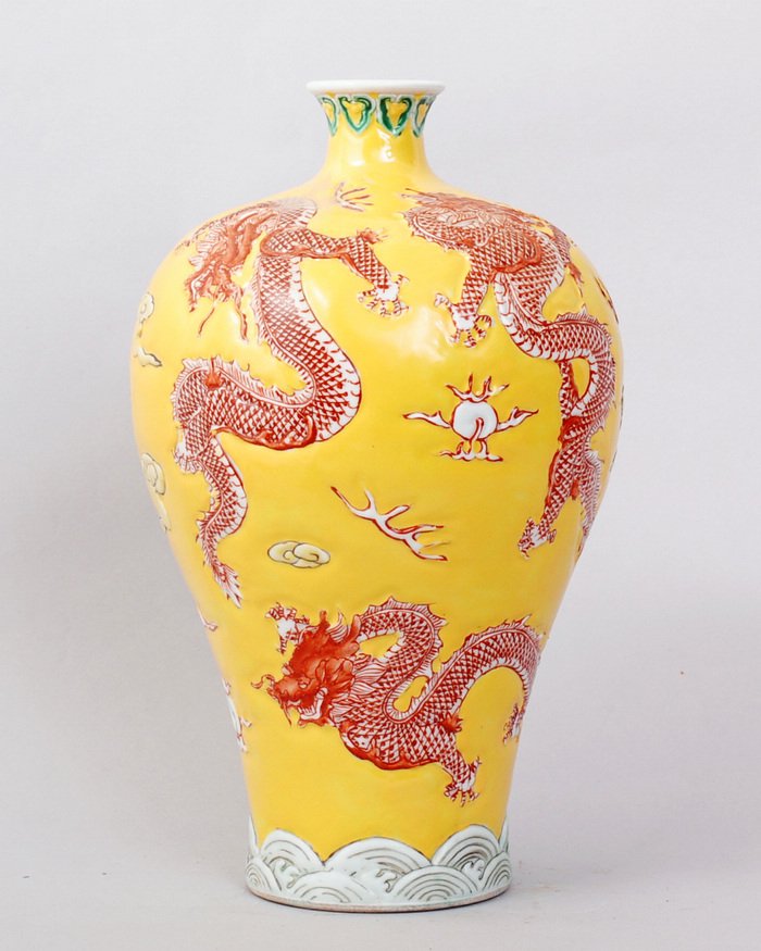 CHINESE QING STYLE PORCELAIN DRAGON VASES: FINELY PAINTED IN RED RAISED DECORATION OF DRAGONS AMONG FIRES AND CLOUDS ABOVE THE WAVE. BOTH 9.75"H,5.5"W. SEAL MARK FOR GREAT QIANLONG PRODUCTION ON BOTTOM.