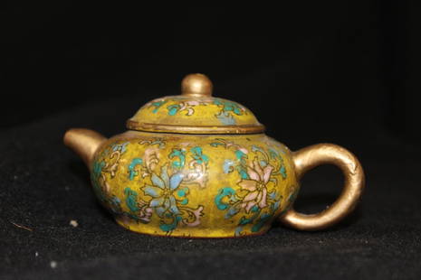 CHINESE SAND TEAPOT: PALACE FRENCH COLOR SAND TEAPOT ENAMELED WITH FLORAL DESIGN AGAINST YELLOW BACK GROUND HAVING GOLD COLOR SPOUT,HANDLE AND LID,MARKED CHINESE ON THE BOTTOM,H.2 7/8",W.4.75".