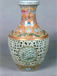 1078: Chinese Revolving Procelain Vase-: Vase in the Famille Palette. Finely molded with an open work body. Finely painted to depicit fish and lotus. The open work revealing a interior blue and white and white vase painted to depict vines