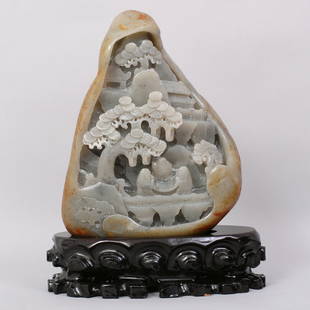 1121: A VERY FINE CHINESECARVED HETIAN ZI JADE BOULDER: FINELY CARVED HETIAN ZI JADE BOULDER WITH SKIN RUSSET, TO DEPICT THREE FIGURES, TREES, BUILDINGS AND MOUNTAINS. CARVED WOODEN STAND.
