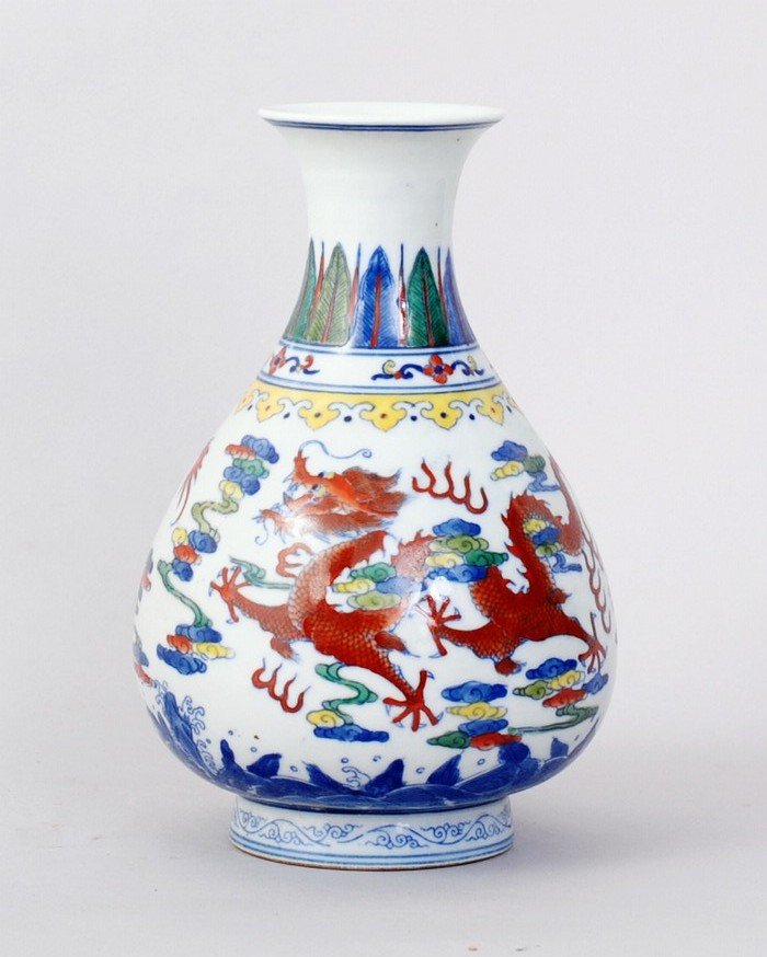 1163: CHINESE QING STYLE PORCELAIN VASES: FINELY PAINTED WITH DRAGONS AMONGST FIRE AND CLOUDS ABOVE THE WAVE. COLOR IN RED,BLUE,YELLOW & GREEN. BOTH 7.25"H,4.5"W. SIX CHARACTER GREAT YONGZHENG PRODUCTION ON BOTTOM.