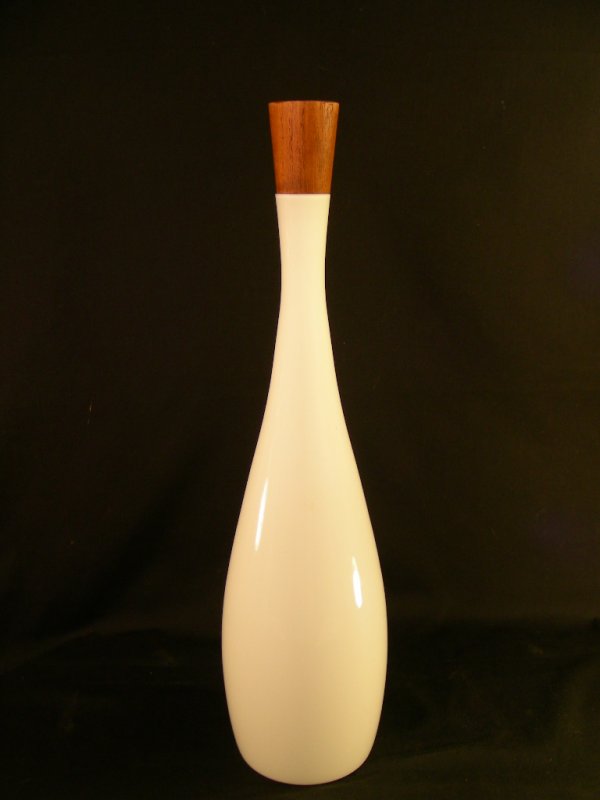 RAYMOR MID CENTURY MODERN GLASS & TEAK DECANTER: Lot # 714: RAYMOR MID CENTURY MODERN GLASS & TEAK DECANTER - Measures with teak wood stopper 19" high by 4 1/2" wide. Original label on base reads, "Raymor, Modern in the Tradition of good taste."