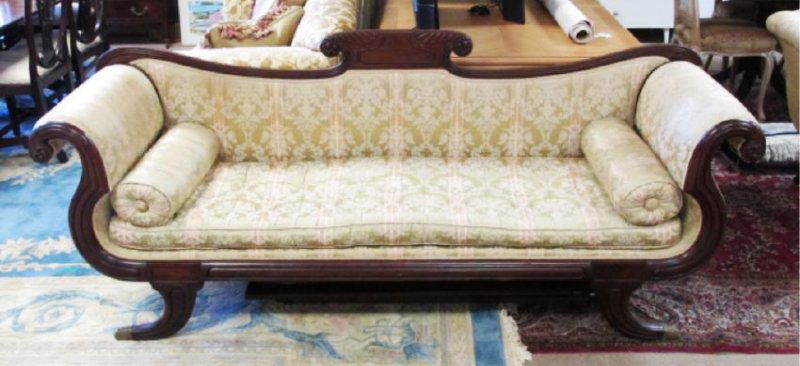 DUNCAN PHYFE STYLE EMPIRE SOFA: Duncan Phyfe style empire sofa measuring a total of 85" wide x 35" tall and 25" deep. Rolled arms and brass feet. Condition: minor signs of discoloration to upholstery, minor splits to wood holding ba