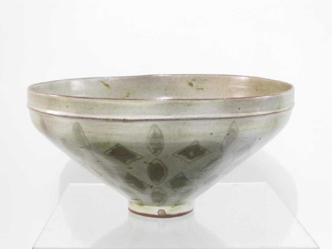 MID CENTURY POTTERY BOWL BY FRANCINE DEL PIERRE: Mid century modern glazed pottery footed bowl by Francine Del Pierre. Measures a total of 6" tall x 12" in diameter. Marked along the edge of the foot with a single circular mark (mark of Francine Del