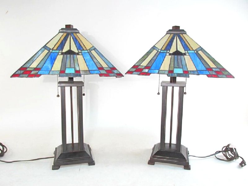 PAIR FRANK LLOYD WRIGHT/ARTS & CRAFTS STYLE LAMPS: Frank Lloyd Wright/ Arts and Crafts style table lamps. Each lamp measures 24.5" tall x 16" wide at shade. Condition: generally good, minor bends to leaded glass shade, see images. Weight: 22 lbs.
