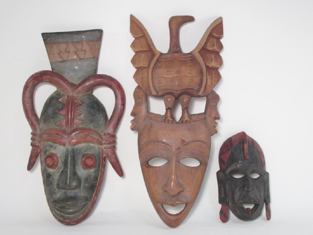 THREE CARVED WOOD TRIBAL MASKS (1 of 9)