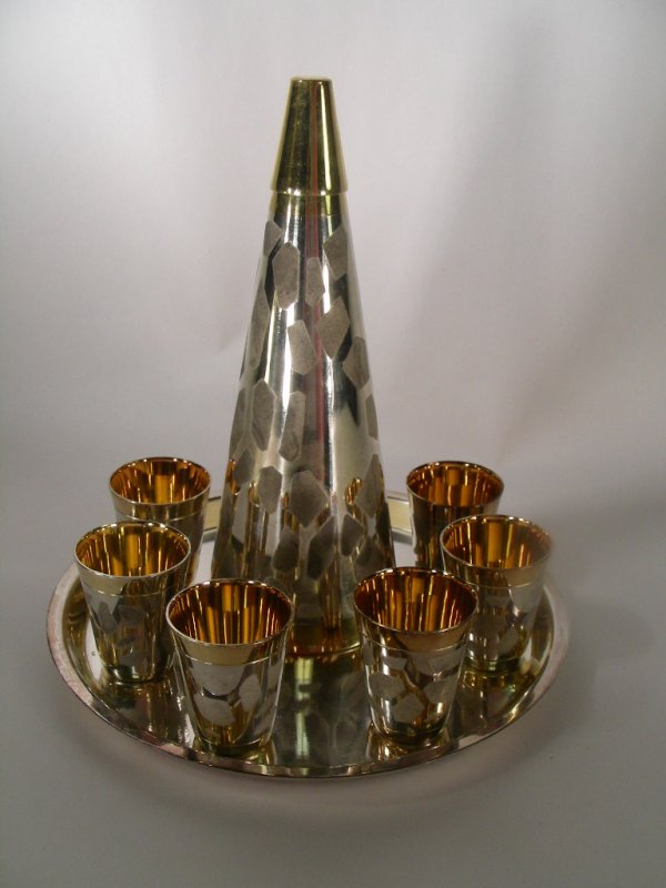 SILVER AND GOLD PLATED CORDIAL SET 8 PCS: Lot 620: SILVER AND GOLD PLATED CORDIAL SET 8 PCS - Silver and gold plated cordial set, consisting of a round tray, 6 cordial glasses and a 7 inch flask. No maker marks. Discoloration on tray. bottom.