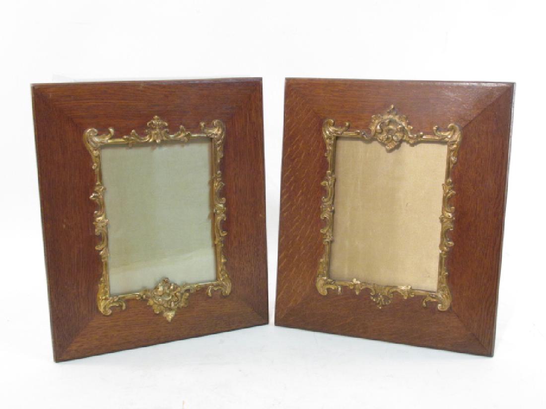 PAIR ENGLISH ENCINO WOOD PICTURE FRAMES: Pair of antique English encino wood picture frames, embellished by parcel gilt carved scroll and foliate borders. Measures 16" tall x 13.5" wide. Condition good. Weight: approx. 6 lbs.