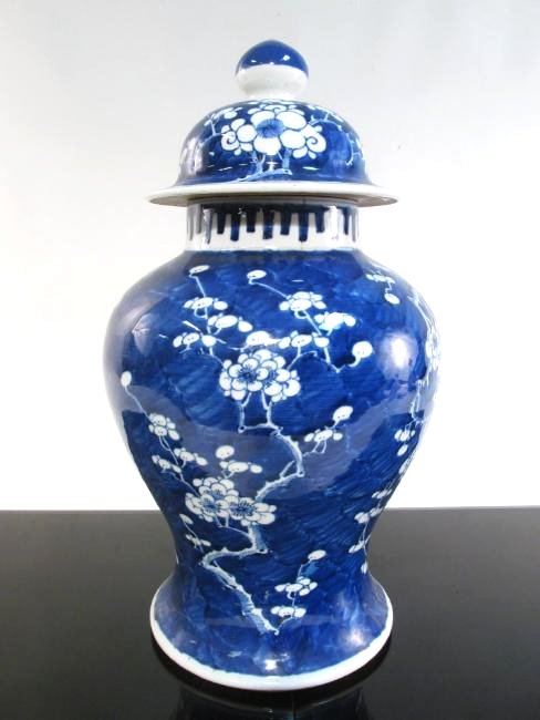 CHINESE QING DYNASTY PORCELAIN PRUNUS GINGER JAR: Chinese Qing Dynasty blue and white porcelain prunus ginger jar with lid. Measures a total of 18" tall. Condition: small hairline to rim and lid, see images. Weight: 11 lbs.