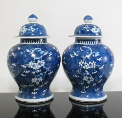 PAIR CHINESE QING DYN PORCELAIN PRUNUS GINGER JARS: Pair of Chinese Qing Dynasty porcelain prunus pattern ginger jars, each measuring 11.8" tall. Condition: small flake to edge of one lid, see images. Weight: 9 lbs.