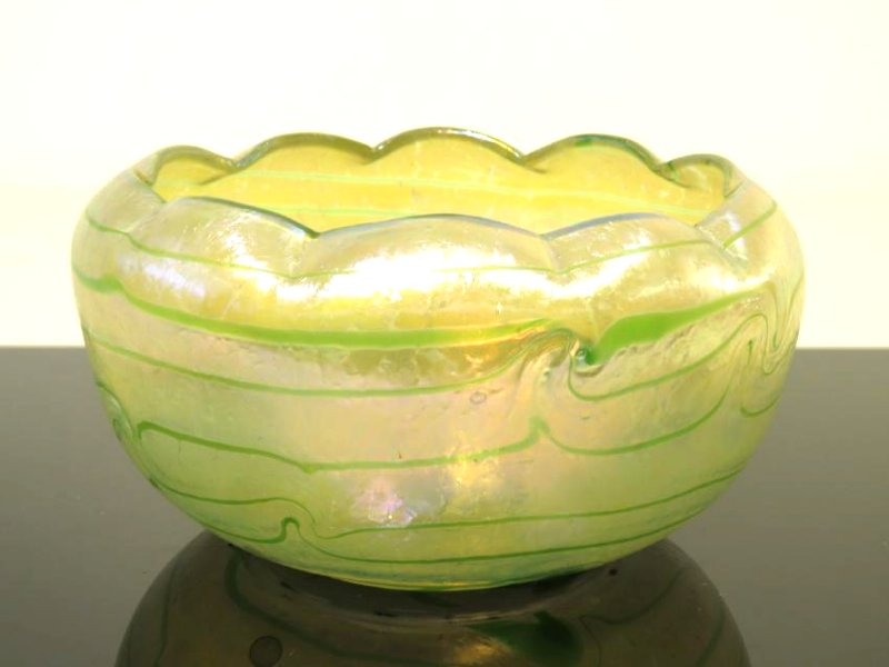 FAVRILE STYLE HAND BLOWN IRIDESCENT ART GLASS BOWL: Hand blown art glass bowl in the manner of Loetz, unsigned. Measures 9.5" in diameter x 5" tall. Condition: good, no signs of damages, see images. Weight: 4 lbs.