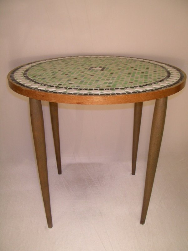 VINTAGE MID CENTURY MOSAIC STYLE TILE TOP TABLE: Small tiles inlaid in a geometric form to a round wooden frame. Light, medium and dark green, black and white high gloss tiles, some with gold gilt flecks. Table measures 21" wide by 18 3/4" tall. Goo