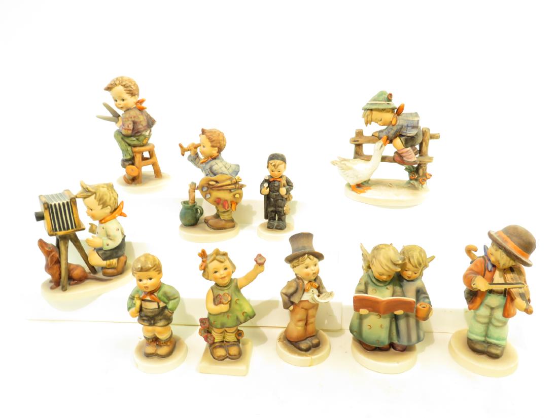 LOT OF TEN HUMMEL FIGURINES: Lot of 10 Hummel figurines. Includes: "Little Tailor" # 308, "The Artist" # 304, "Angel Duet" # 193 (repair to wing), "Trumpet Boy" #97, "Little Fiddler" # 2, "Barnyard Hero" # 195, "The Photographer"