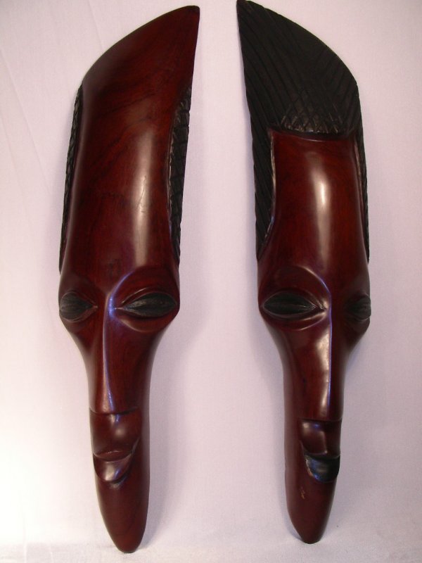 AFRICAN SOUVENIR MASKS: Carved wooden African souvenir masks (pr), 20 inches. One mask has a hairline crack running from the top of it to the nose approx. 14" long. Other mask is in good condition.
