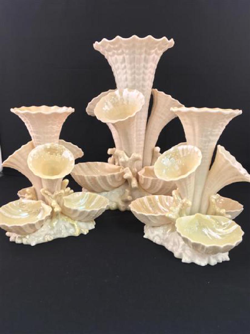 IRISH BELEEK MARINE TRUMPET VASES 3 PC: Three Irish Belleek Marine Vases or Epergnes. Each with 4 trumpets or horns. The central trumpets with three smaller surrounding trumpets, the triangular coral molded base with three fluted shells. La