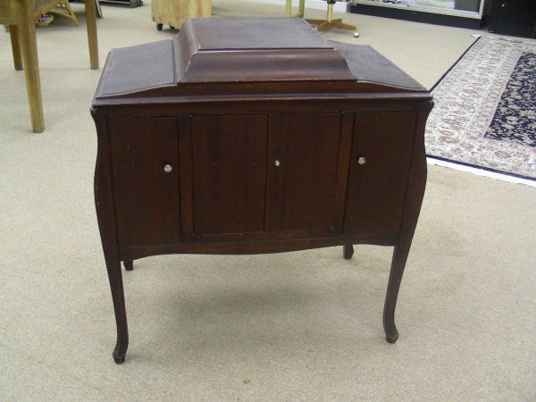 ANTIQUE VICTROLA VICTOR TALKING MACHINE 1921: Mahogany case, three doors with interior storage. Surface wear scratches and dings to case. Lift top hinge reveals turntable with chrome arm. Label under lid. Measures 36" tall by 35" wide and 21" dee