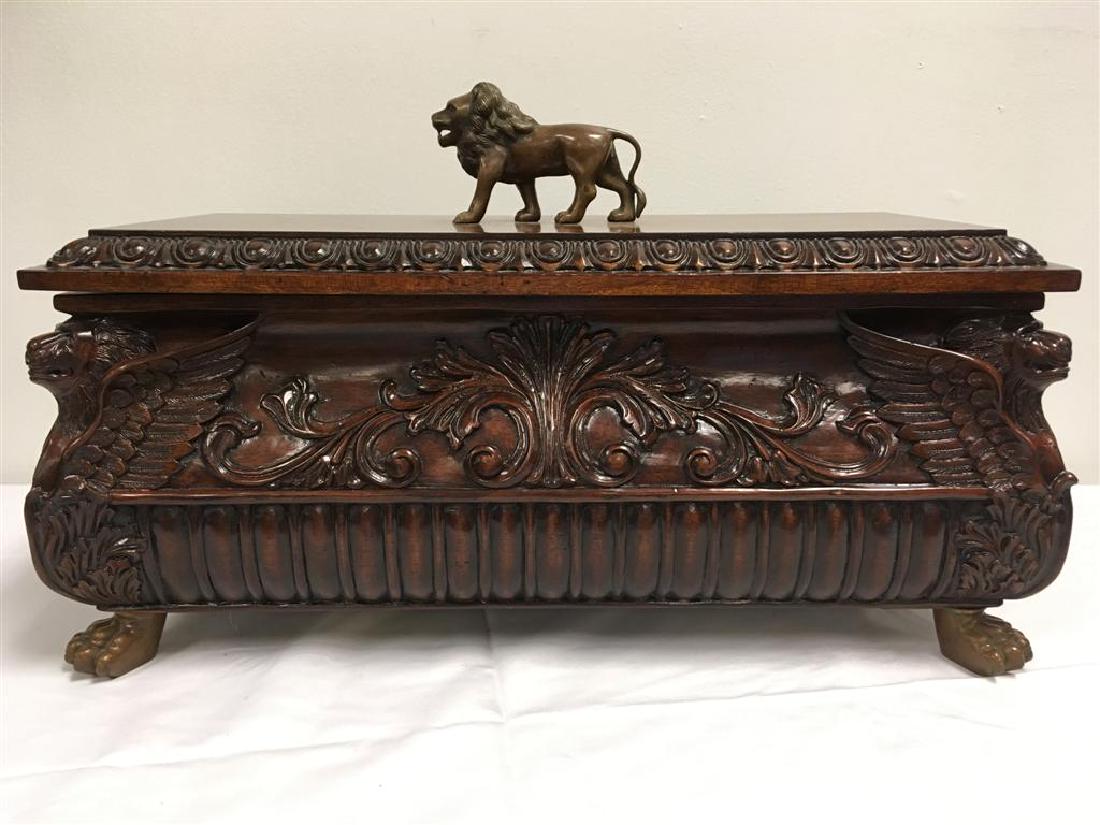 MAITLAND-SMITH LARGE JEWELRY BOX w/ LIONS: Maitland-Smith mahogany carved jewelry box with bronze lion finial and carved winged lions on each corner. 23" x 11" x 14" tall.