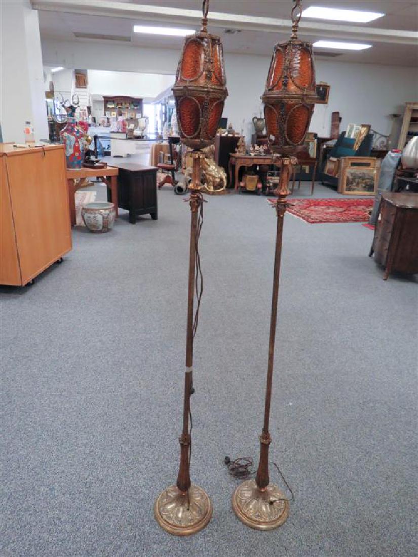 2 GOTHIC OR SPANISH REVIVAL TORCHIERE FLOOR LAMPS: A pair of Gothic or Spanish revival torchiere floor lamps. Each measures 47" tall with lanterns at 11" tall and bases 11" wide. Condition is good. No apparent maker's marks.