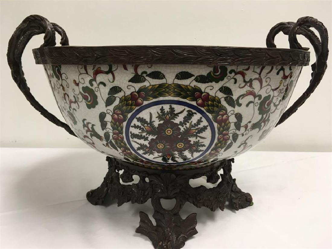 MAITLAND-SMITH CENTER BOWL WITH BRONZE MOUNTS: Maitland-Smith two handled center bowl. Bronze rim, handles, and base. Floral decorated ceramic body. 24" handle to handle and 11" tall. Good condition