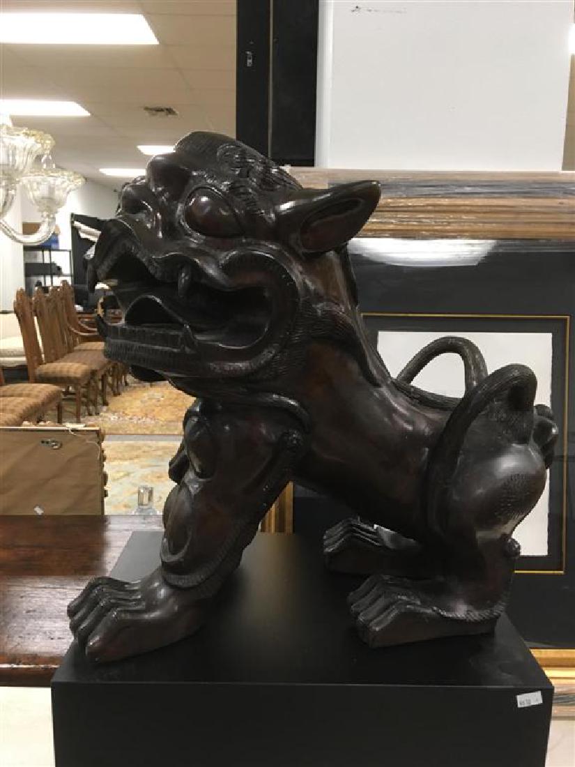 PAIR CHINESE BRONZE FOO DOGS: Pair of Chinese bronze foo dogs. Male and female with baby. Each statue sits on a black plinth base. Each dog measures 16.75" tall x 18" long and 13" wide, the bases are 16" long by 12" wide and the f